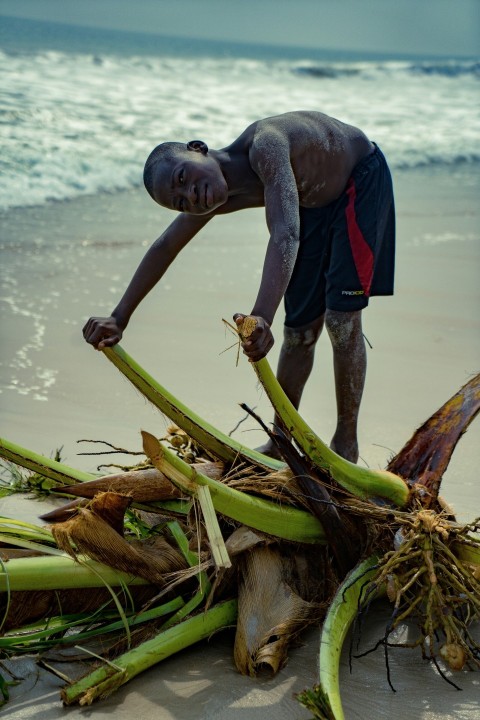 a person with a large pile of snakes on a beach