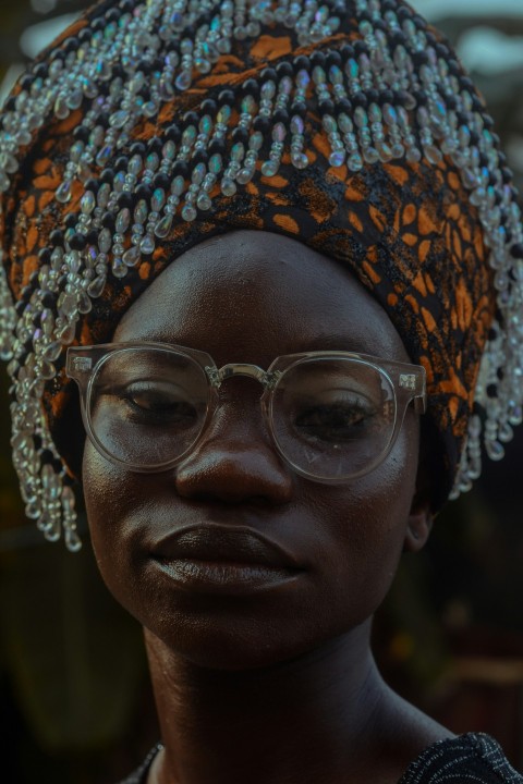 woman wearing orange and black head dress