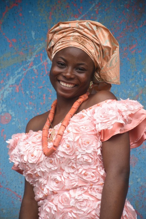 woman in pink and white floral dress smiling