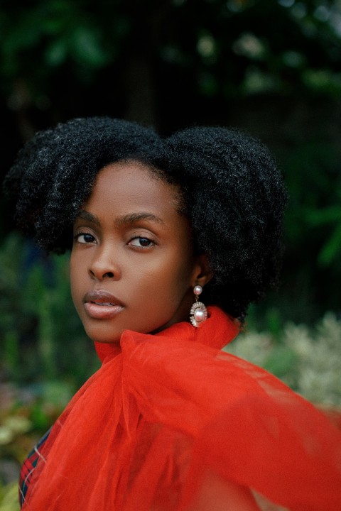 a woman with a red dress and earrings