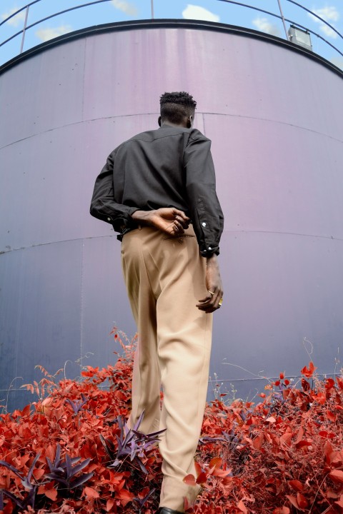 man standing facing tank