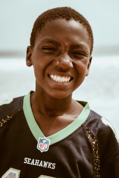 a young boy is smiling for the camera