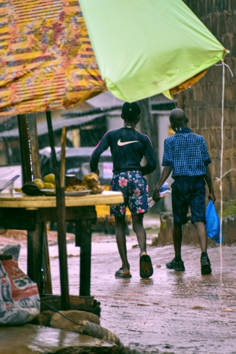 a couple of people walking down a street