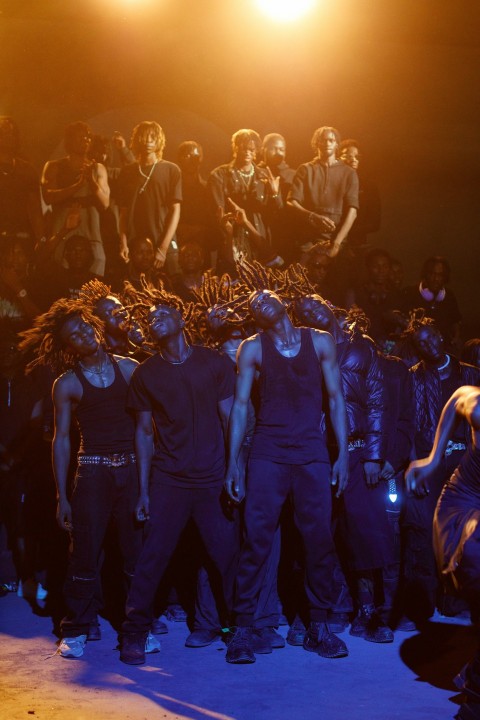 a group of people standing in front of a stage