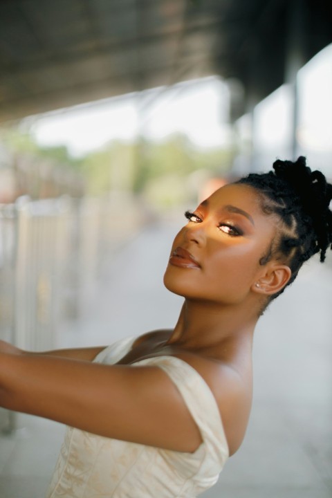 a woman in a white dress holding a cell phone