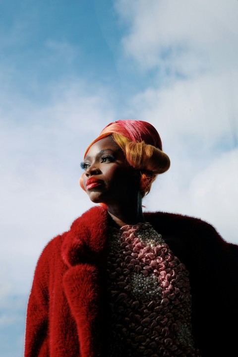 a woman wearing a red coat and a red hat