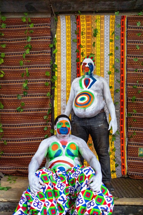 a man standing next to a statue of a clown