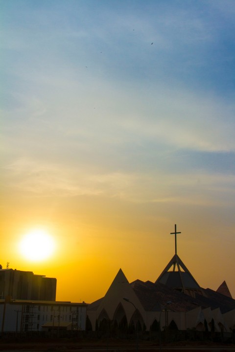 silhouette of building during sunset