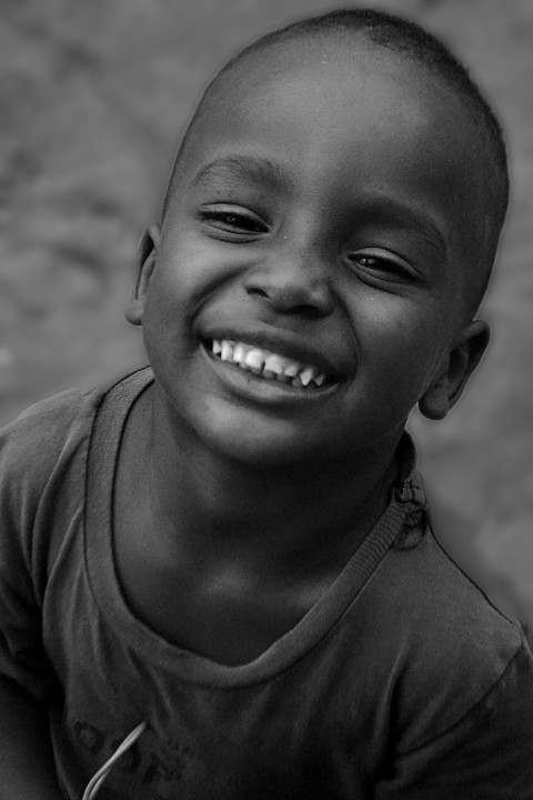 a close up of a young boy smiling