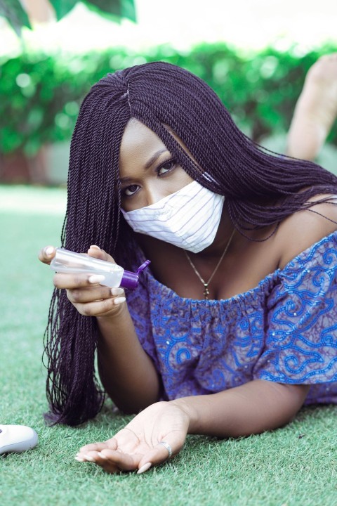 woman in blue floral dress with white face mask