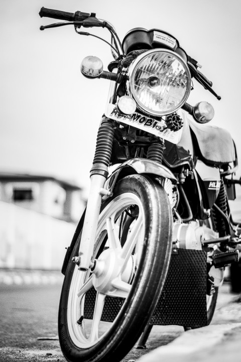 grayscale photo of motorcycle on road