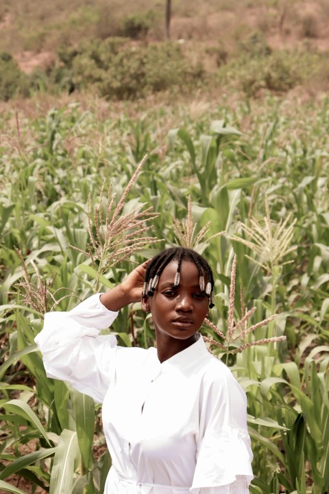 a woman standing in a field of corn