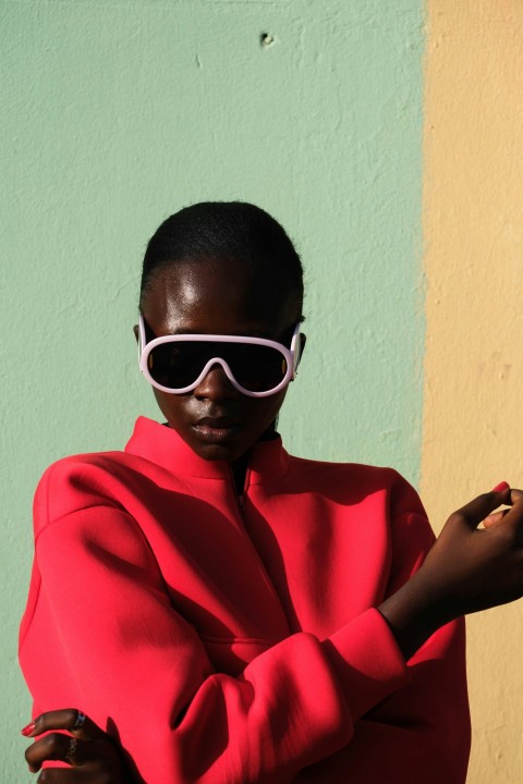 a woman in a red shirt and white sunglasses s