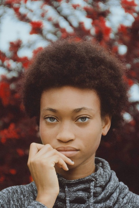 close up photography of woman putting her hand on her mouth