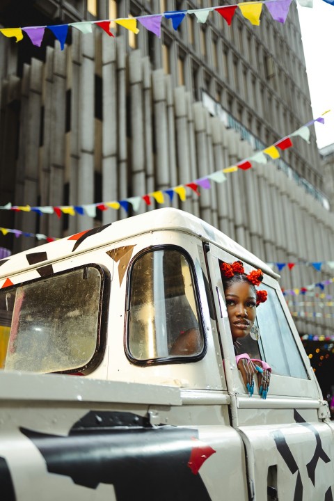 a woman in a white jeep driving down a street 4sYLNN_