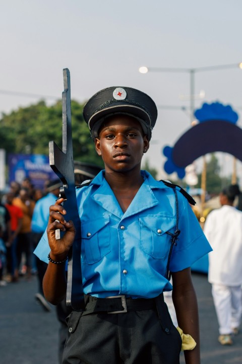 a man in a blue shirt holding a pair of scissors 0OS