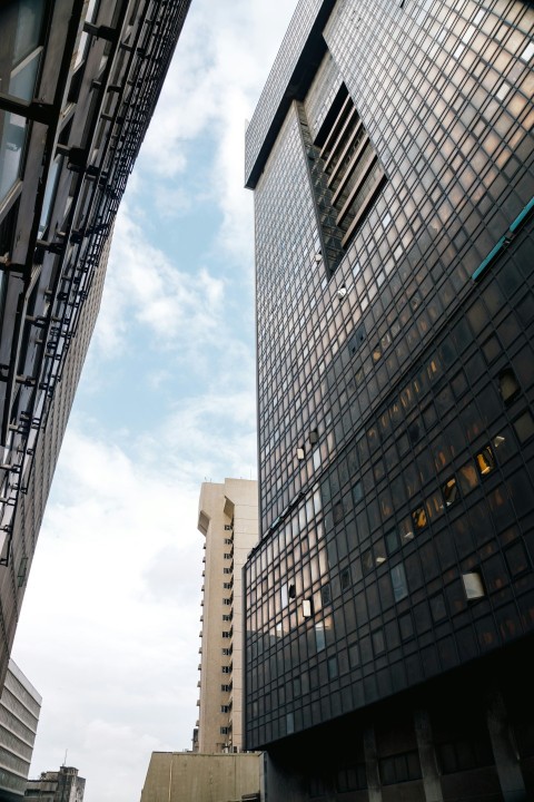 a couple of tall buildings sitting next to each other