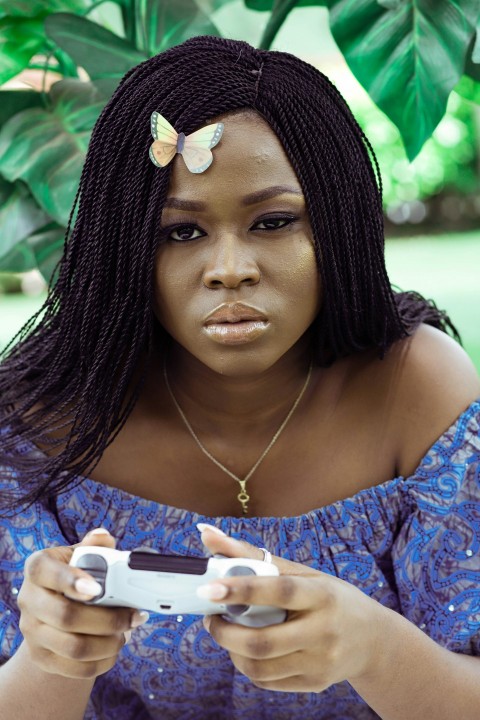 woman in blue and green floral dress holding white smartphone