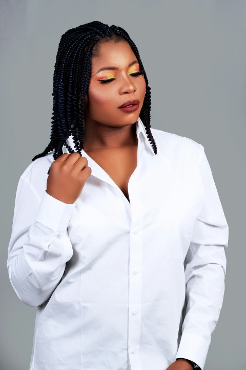 woman in white dress shirt wearing black and silver beaded necklace