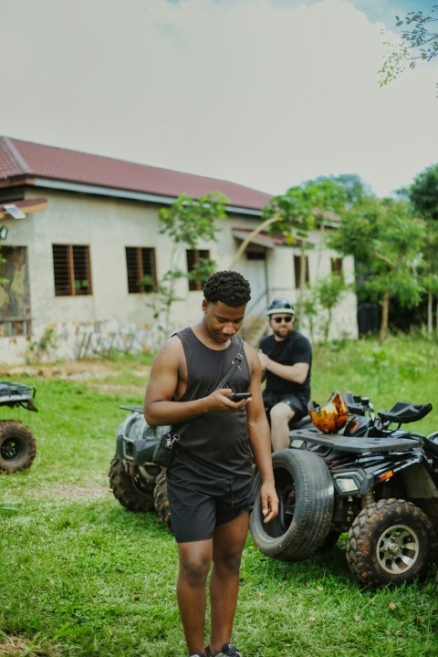 a man standing next to a man on a four wheeler cvzAuaQN