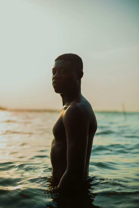 topless man standing on water during daytime WhQYmwmy