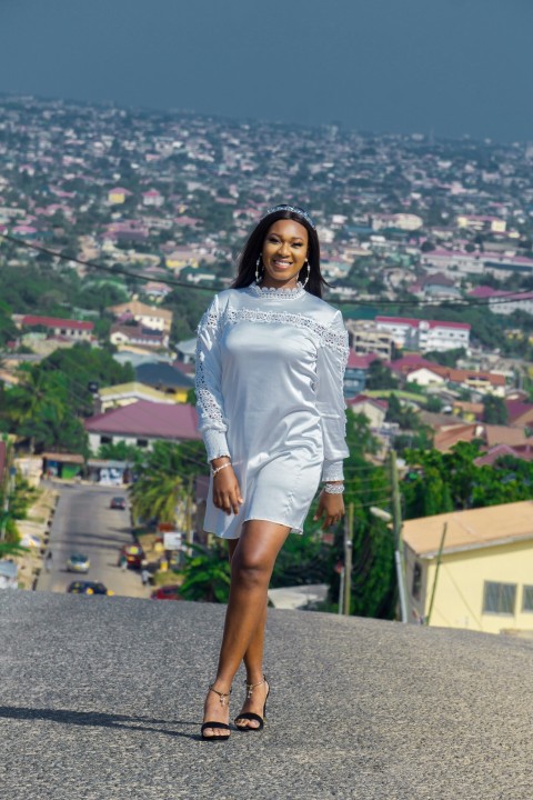 woman in white long sleeve shirt standing on top of building during daytime