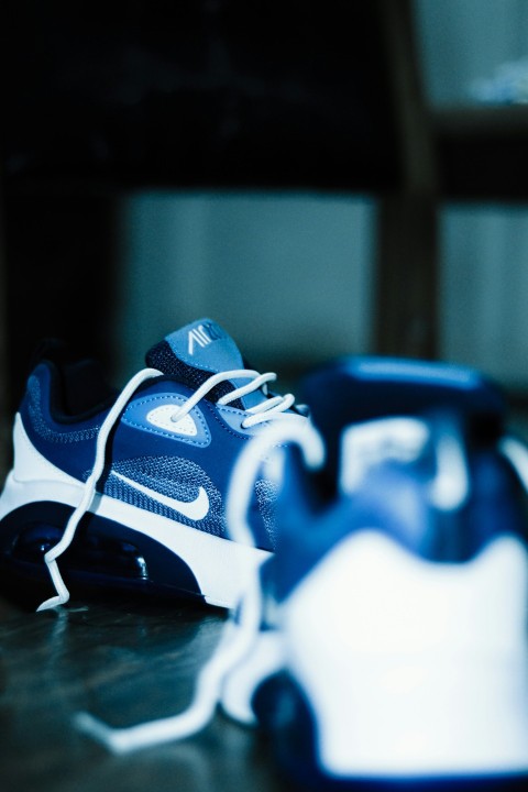 a pair of sneakers sitting on top of a wooden table