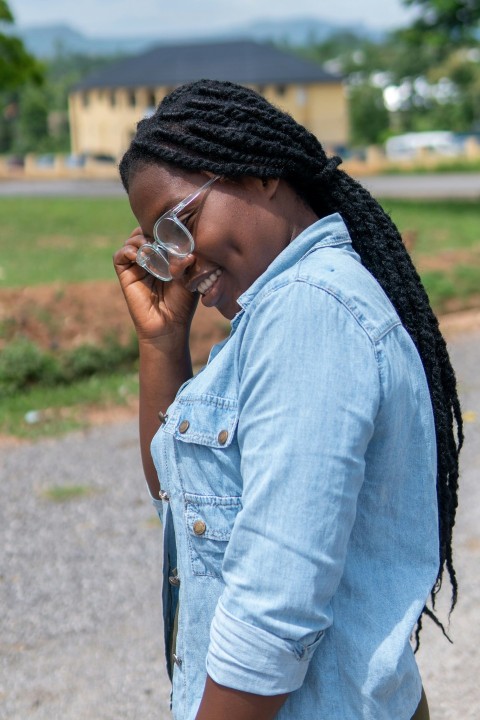 woman in blue denim button up jacket wearing black knit cap and sunglasses