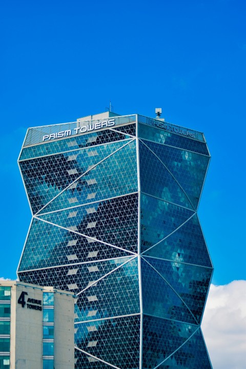 a very tall building with a blue sky in the background 5Y568CAhE