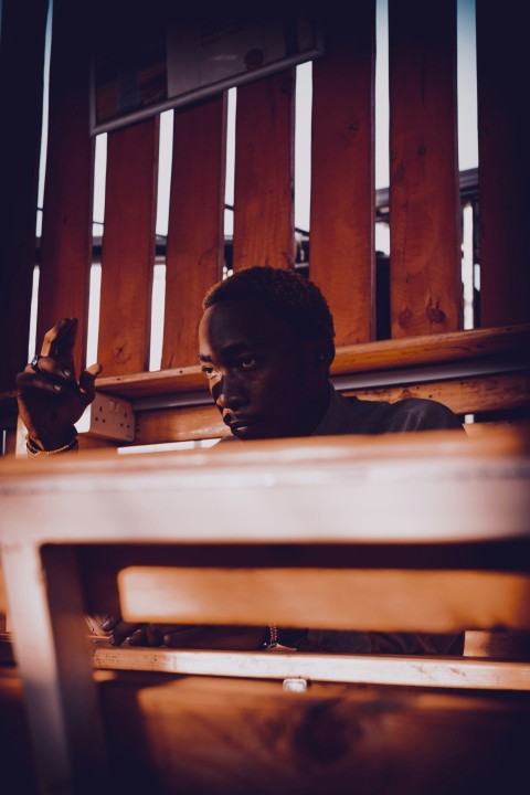 a man sitting at a table with a cell phone in his hand