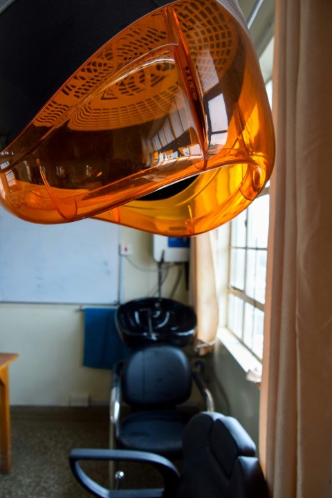 a room with chairs and a light hanging from the ceiling