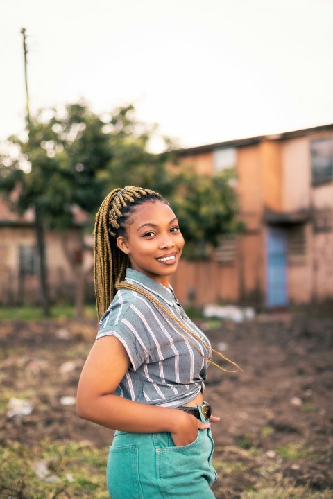 a woman standing in a field with a smile on her face 8