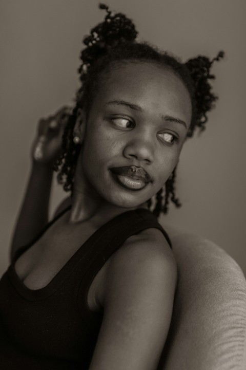 a black and white photo of a woman with a surprised look on her face