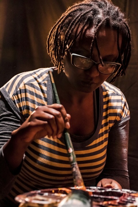 woman in black and white striped shirt wearing eyeglasses