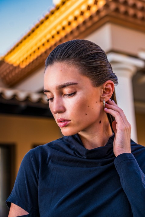 a woman in a black shirt is talking on her cell phone