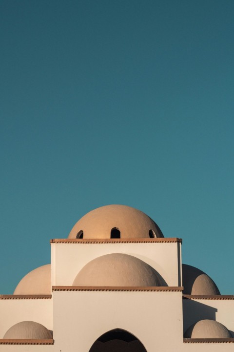 beige concrete building under blue sky during daytime