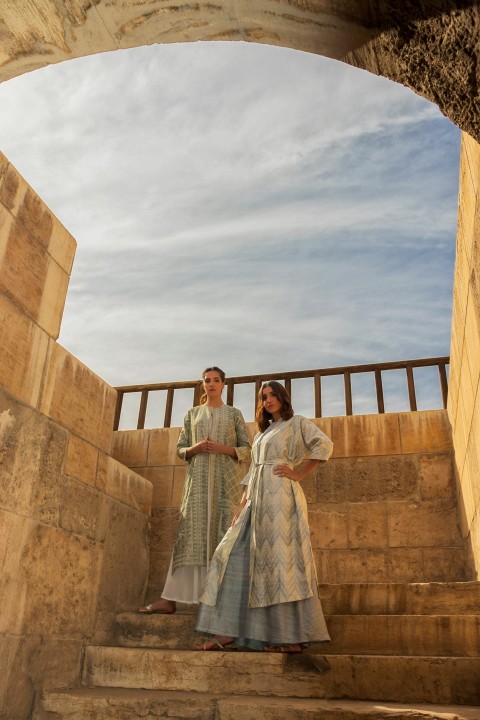 man and woman standing on brown concrete building during daytime