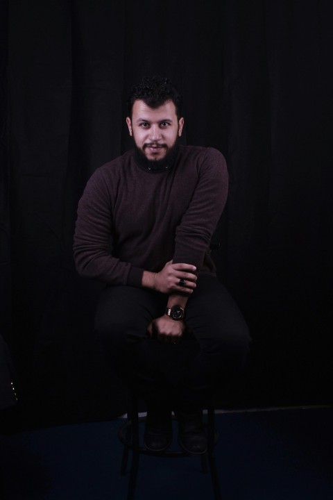 man in black long sleeve shirt sitting on black chair