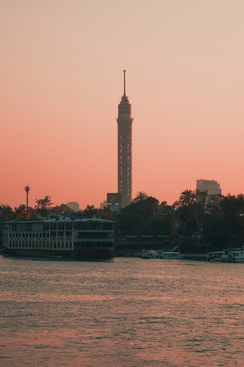 a large body of water with a tower in the background