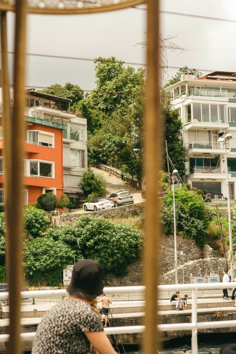 a woman sitting on a bench looking out over the water