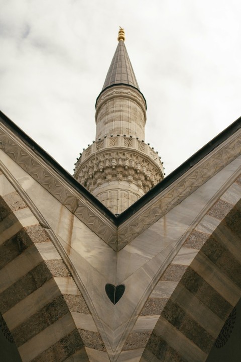 a large building with a tower and a heart shaped window