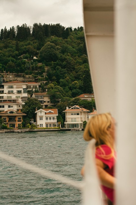 a woman standing on a boat looking out over the water