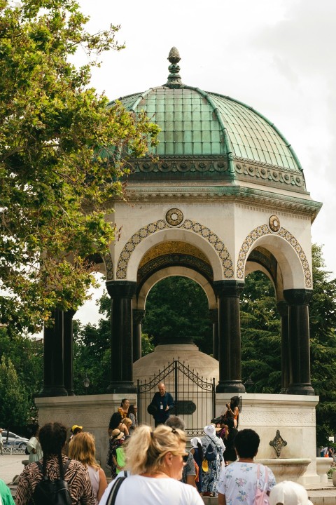 a group of people that are standing in front of a gazebo