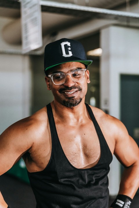 a man wearing a hat and glasses posing for a picture