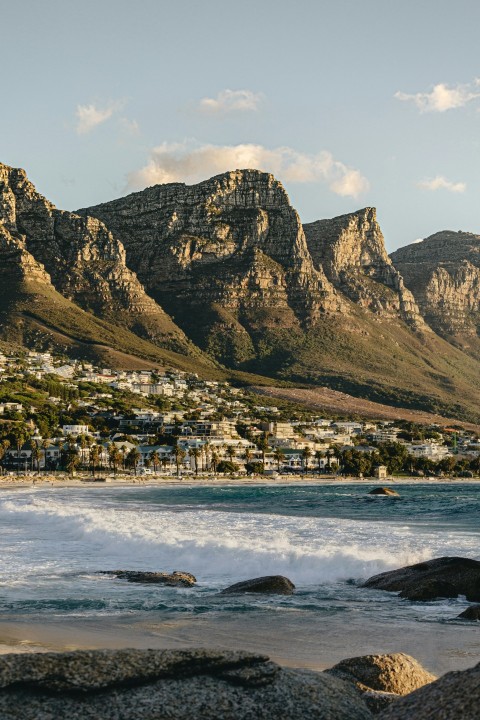 a view of a beach with mountains in the background