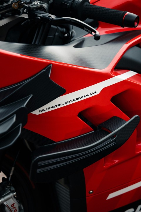 a close up of a red and black motorcycle p0