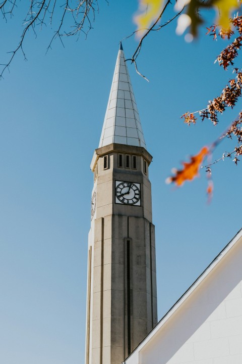 a tall clock tower with a clock on each of its sides