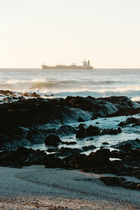 a large ship is in the distance on the ocean SSGFI1JP