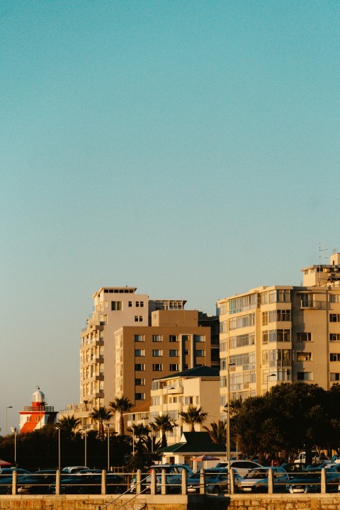 a plane flying over a city with tall buildings