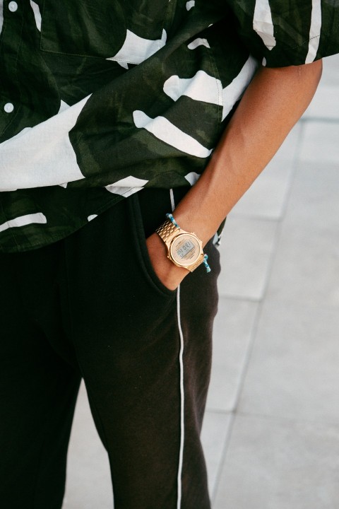 a man wearing a watch and a camo shirt